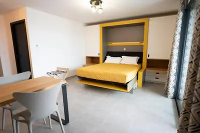 Un ou plusieurs lits dans un hébergement de l'établissement hôtel résidence a torra