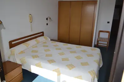 Un ou plusieurs lits dans un hébergement de l'établissement Hôtel Aïtone