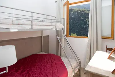 Un ou plusieurs lits dans un hébergement de l'établissement Appartements A Merendella