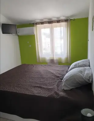 Un ou plusieurs lits dans un hébergement de l'établissement Villa climatisée A Nuciola Prunete Entre mer, montagne et piscine