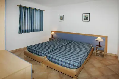 Un ou plusieurs lits dans un hébergement de l'établissement Apartment by Lido Beach & Biguglia Lagoon